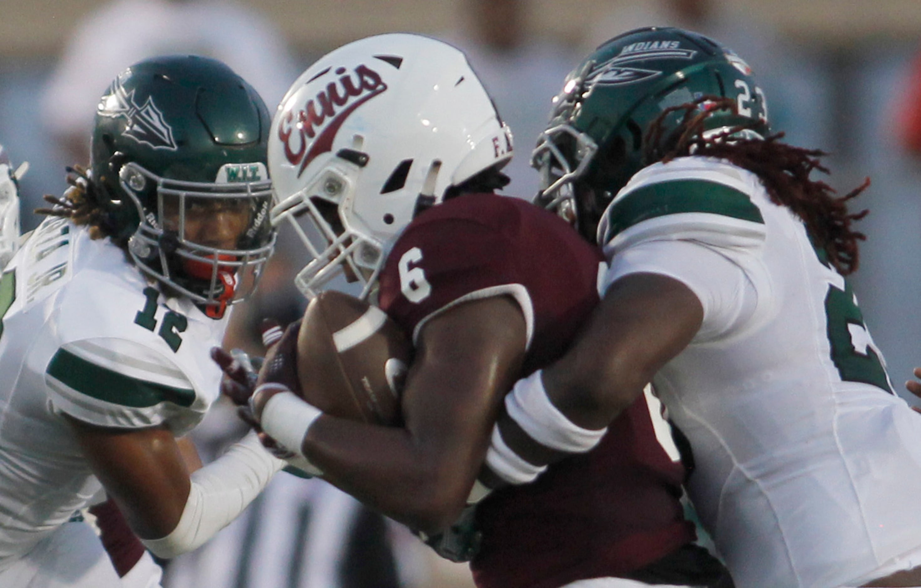 Ennis running back Jamarion Wafford (6) is stopped by Waxahachie defenders Michael Esparza...