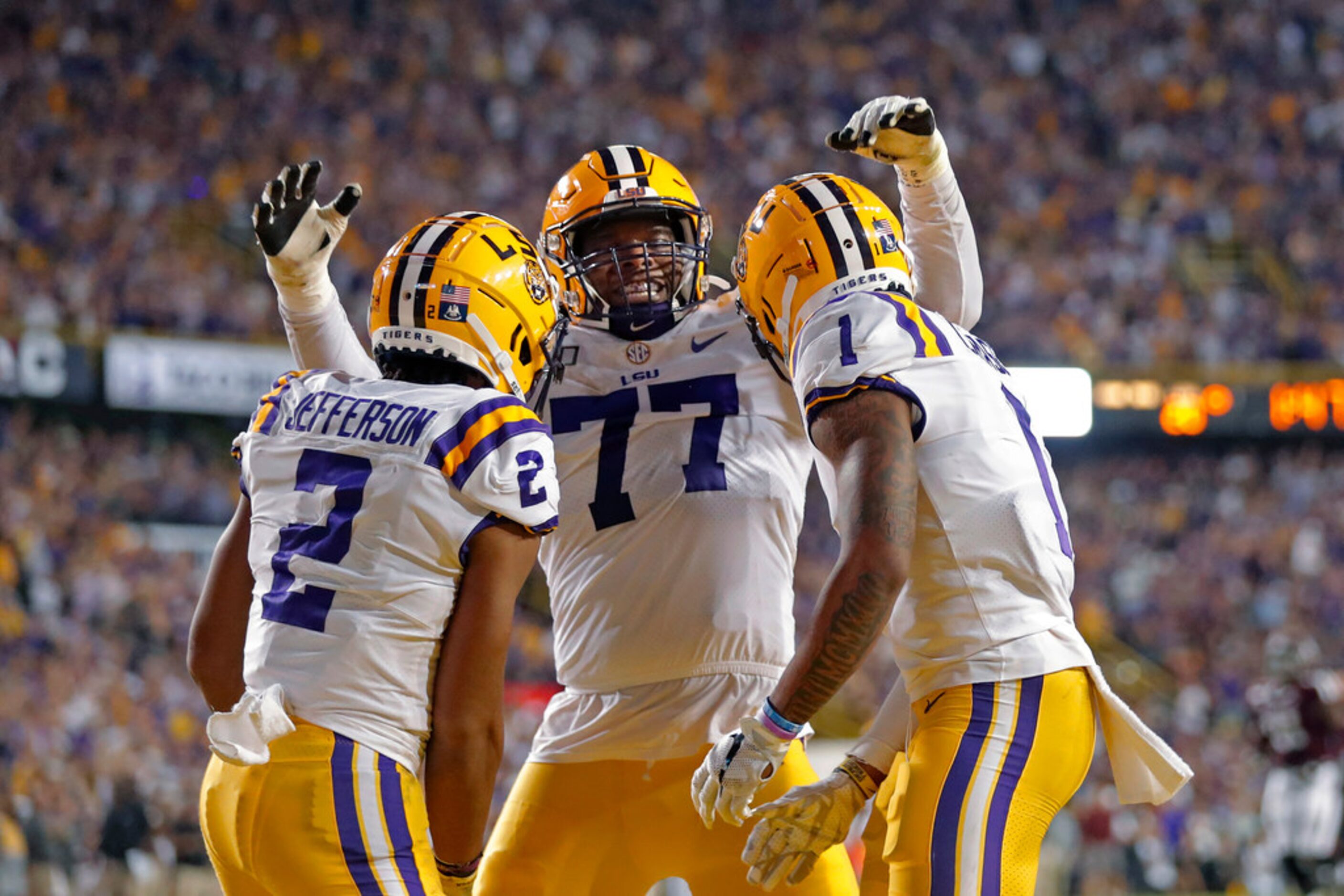 LSU wide receiver Ja'Marr Chase (1) celebrates his touchdown reception with offensive tackle...