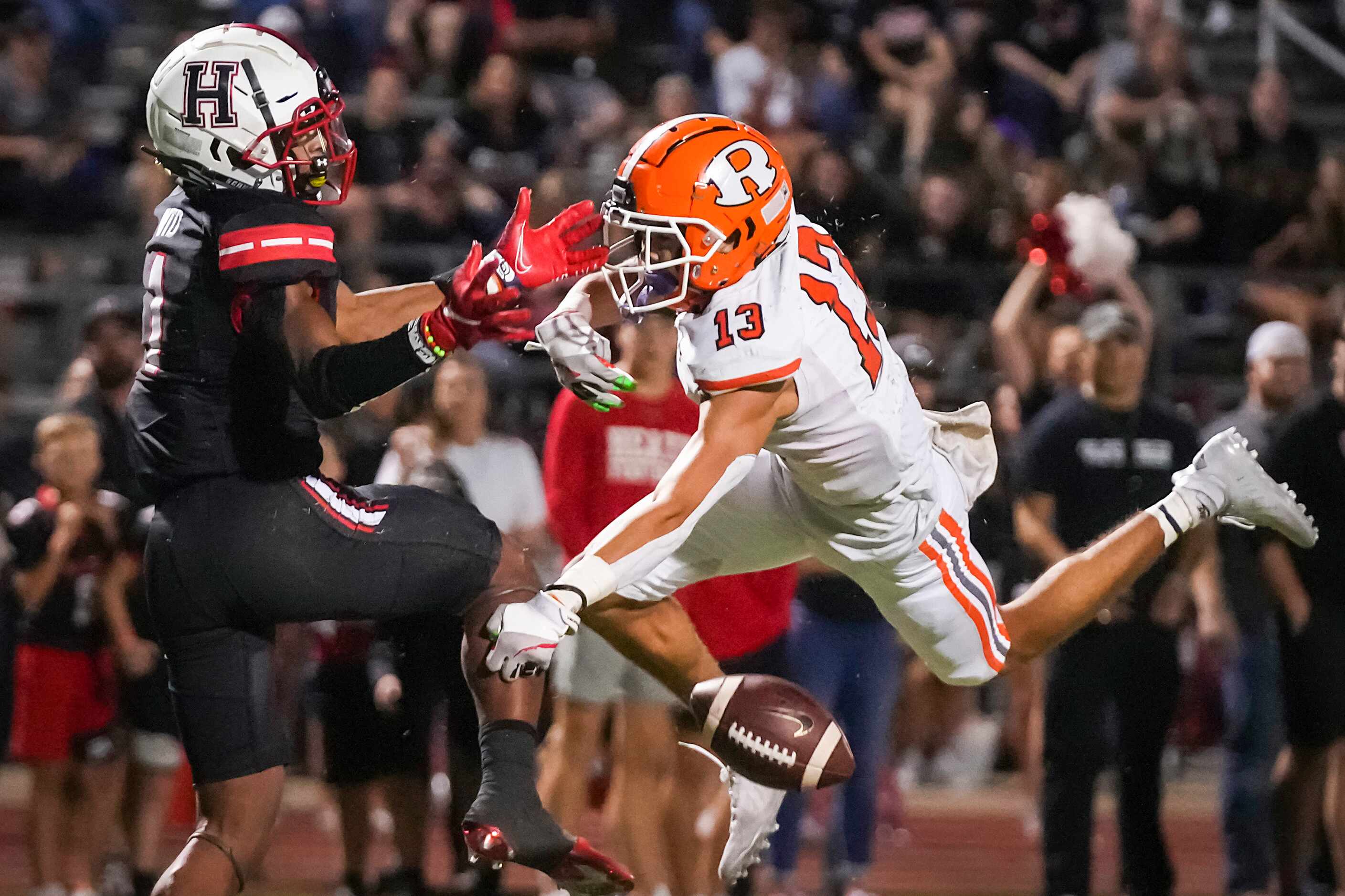 Rockwall defensive back Cadien Robinson (13) breaks up a pass intended for Rockwall-Heath...