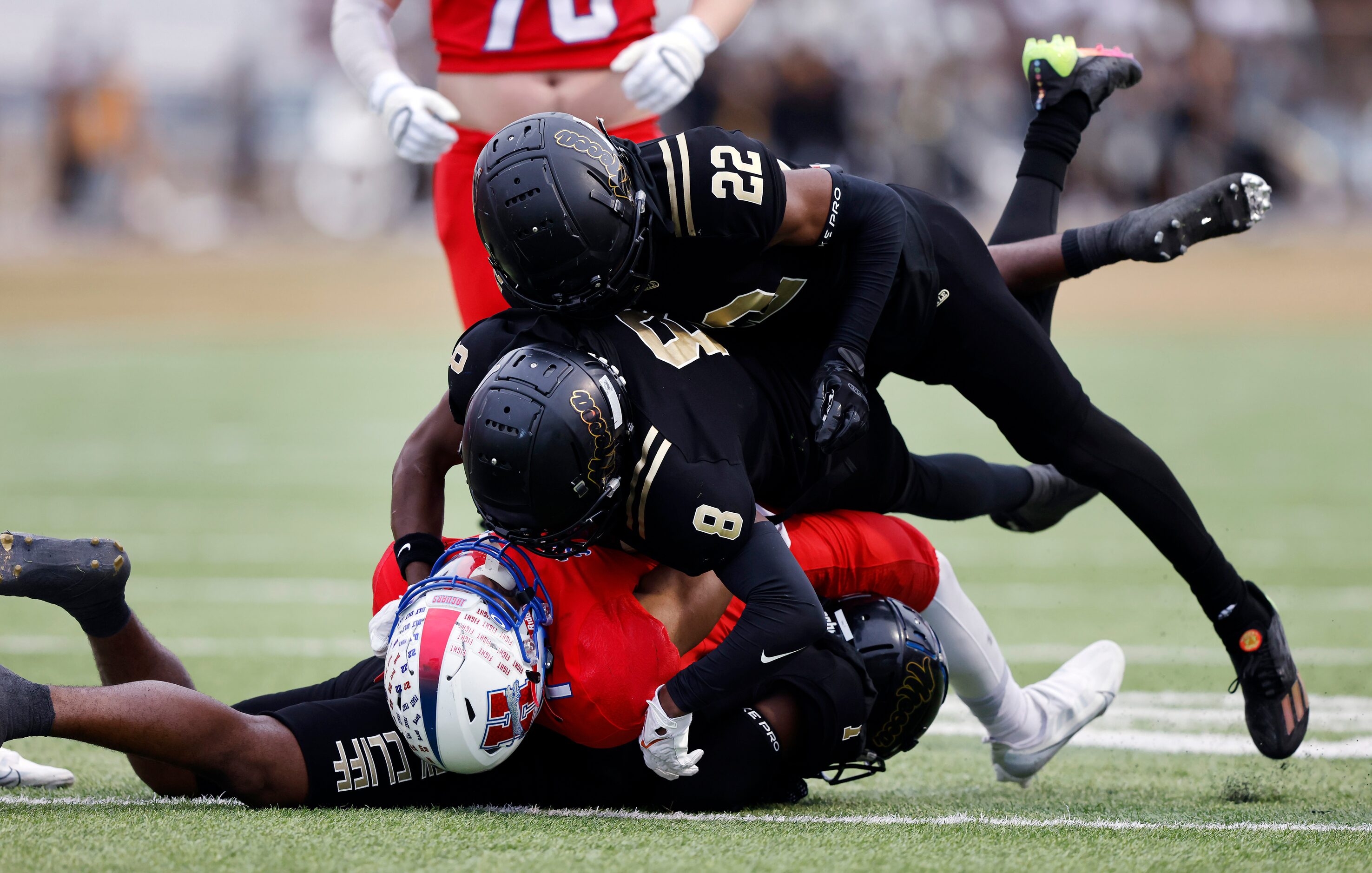 South Oak Cliff defenders Brandon Jones (8) and Jamarion Clark (22) stuff Midlothian...