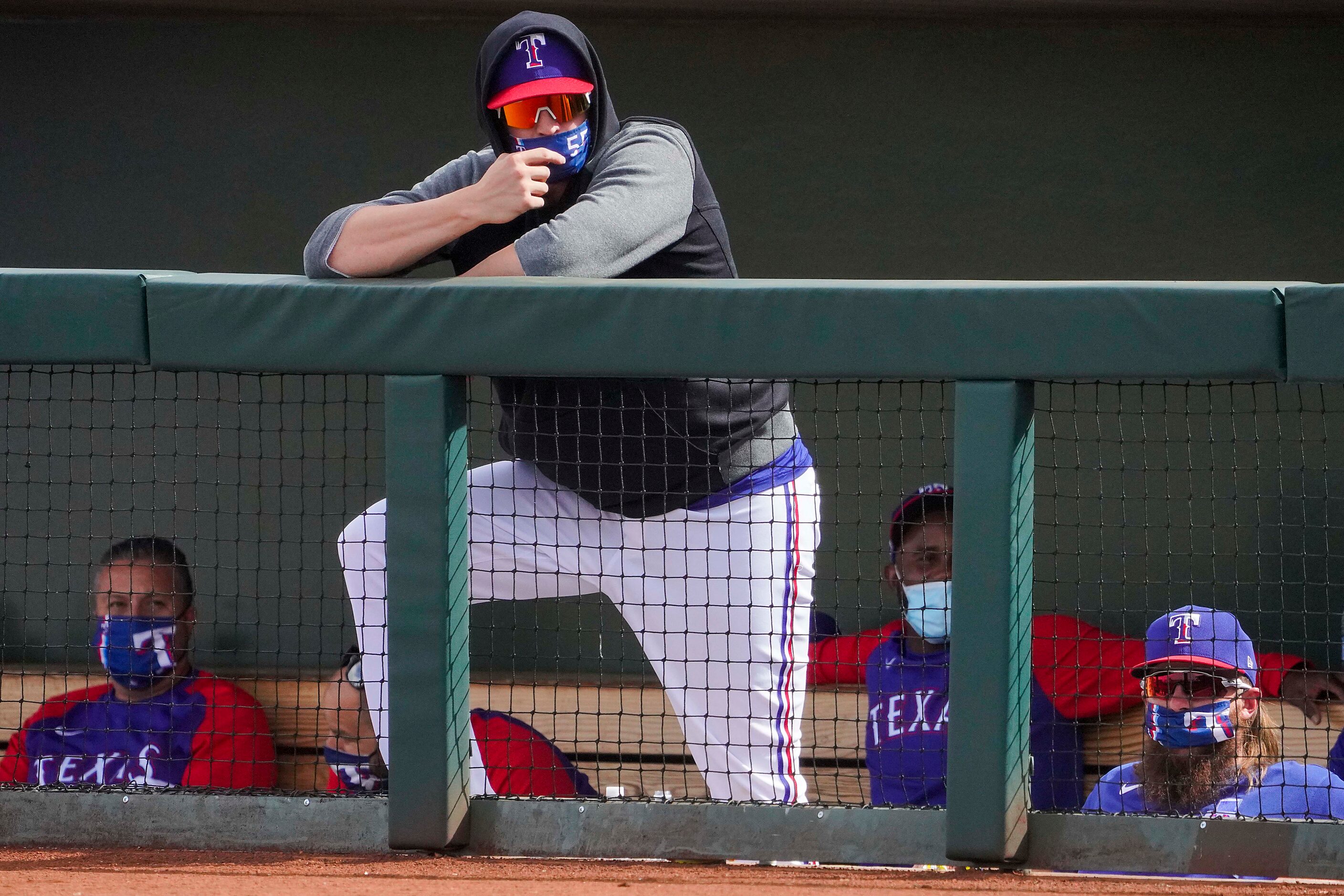 Texas Rangers catcher Sam Huff watches from the dugout during the sixth inning of a spring...