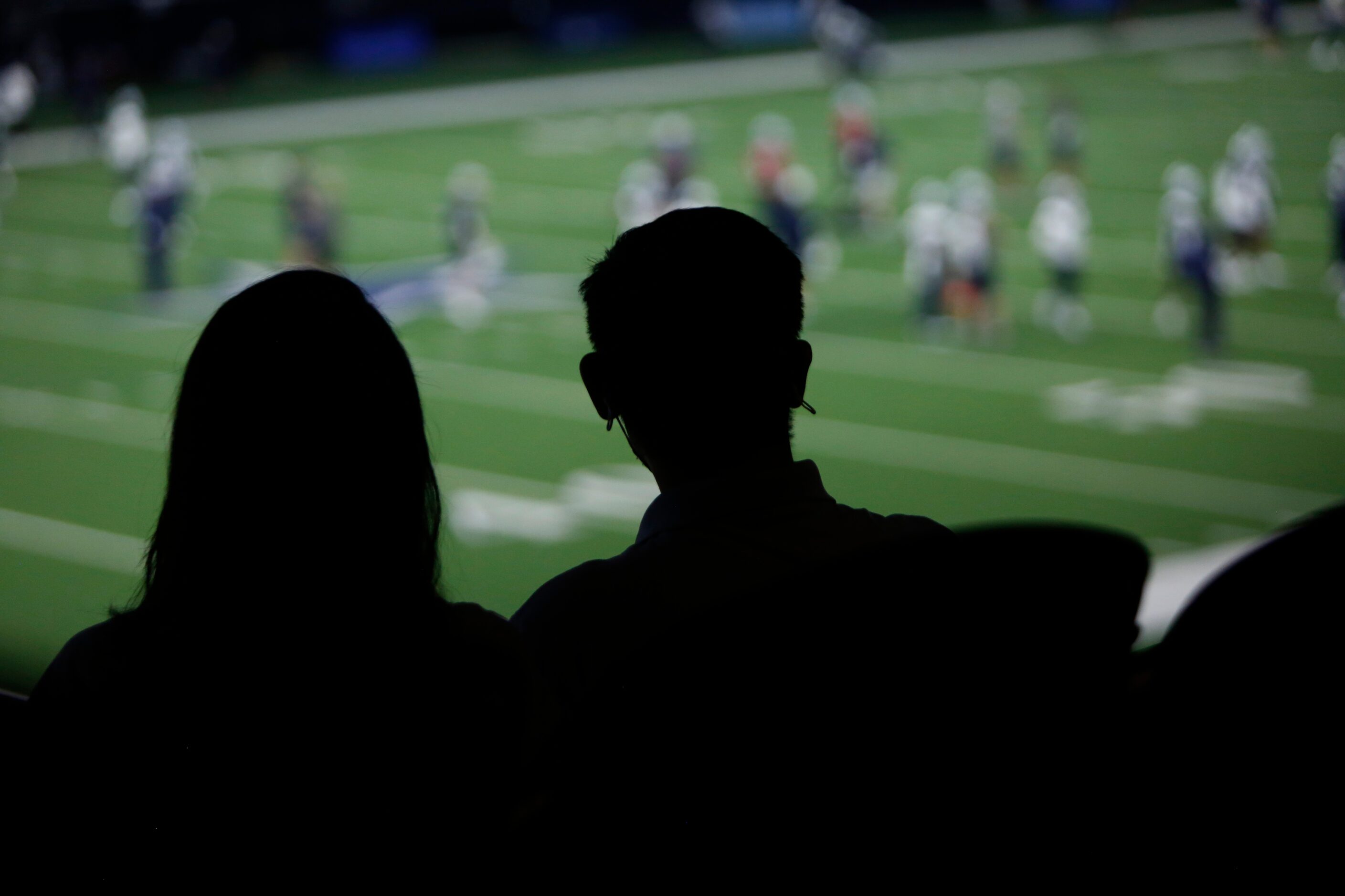 A couple of Dallas Cowboys fans look on during a team practice session. The Cowboys...