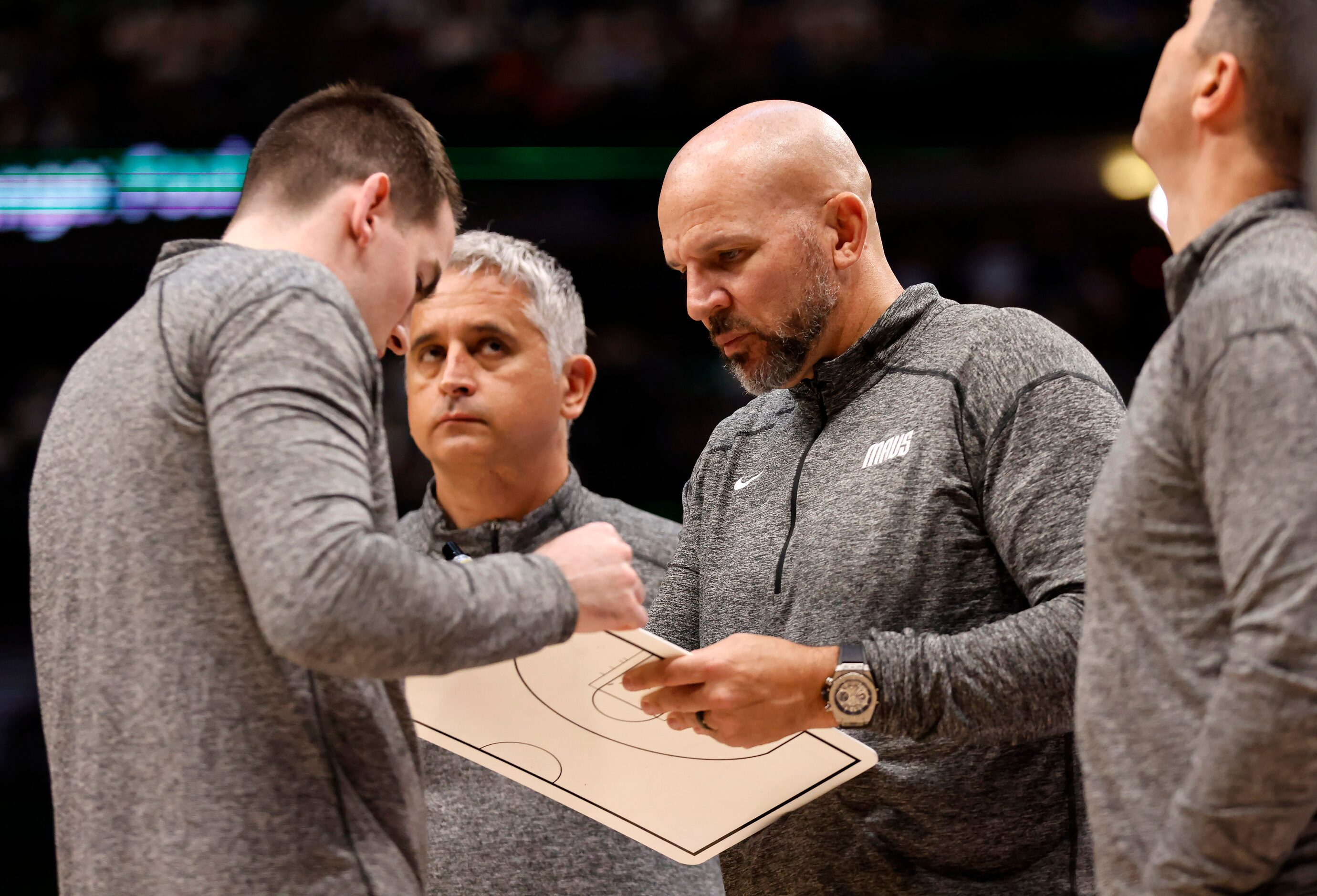 Dallas Mavericks coaches including Jason Kidd (center) draw up a second half play after the...