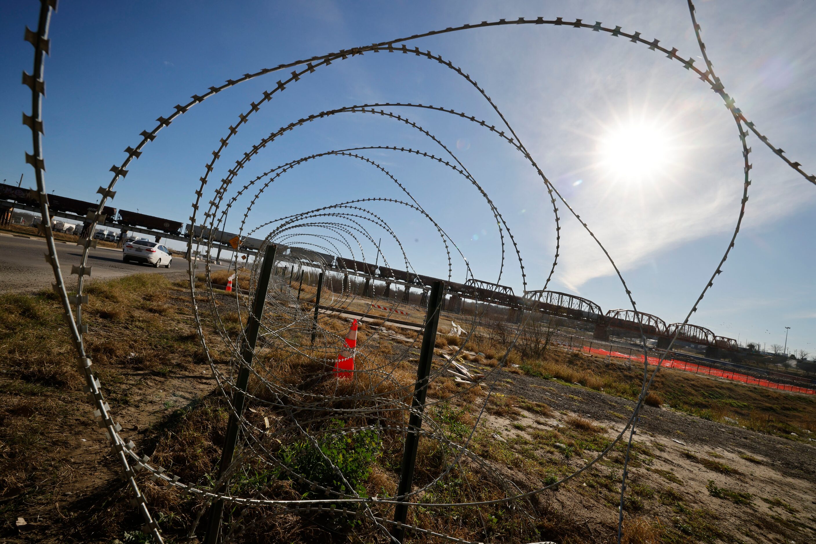 Razor wire coils are seen near a railroad bridge,Tuesday, Jan. 30, 2024, in Eagle Pass. 