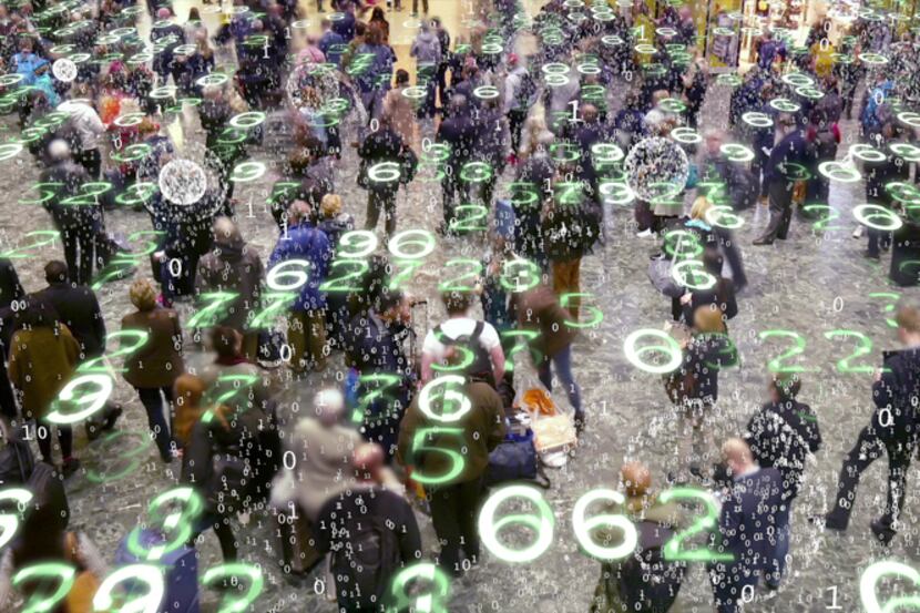 Binary code bursts from phones held by people with a matrix style overlay of glowing...