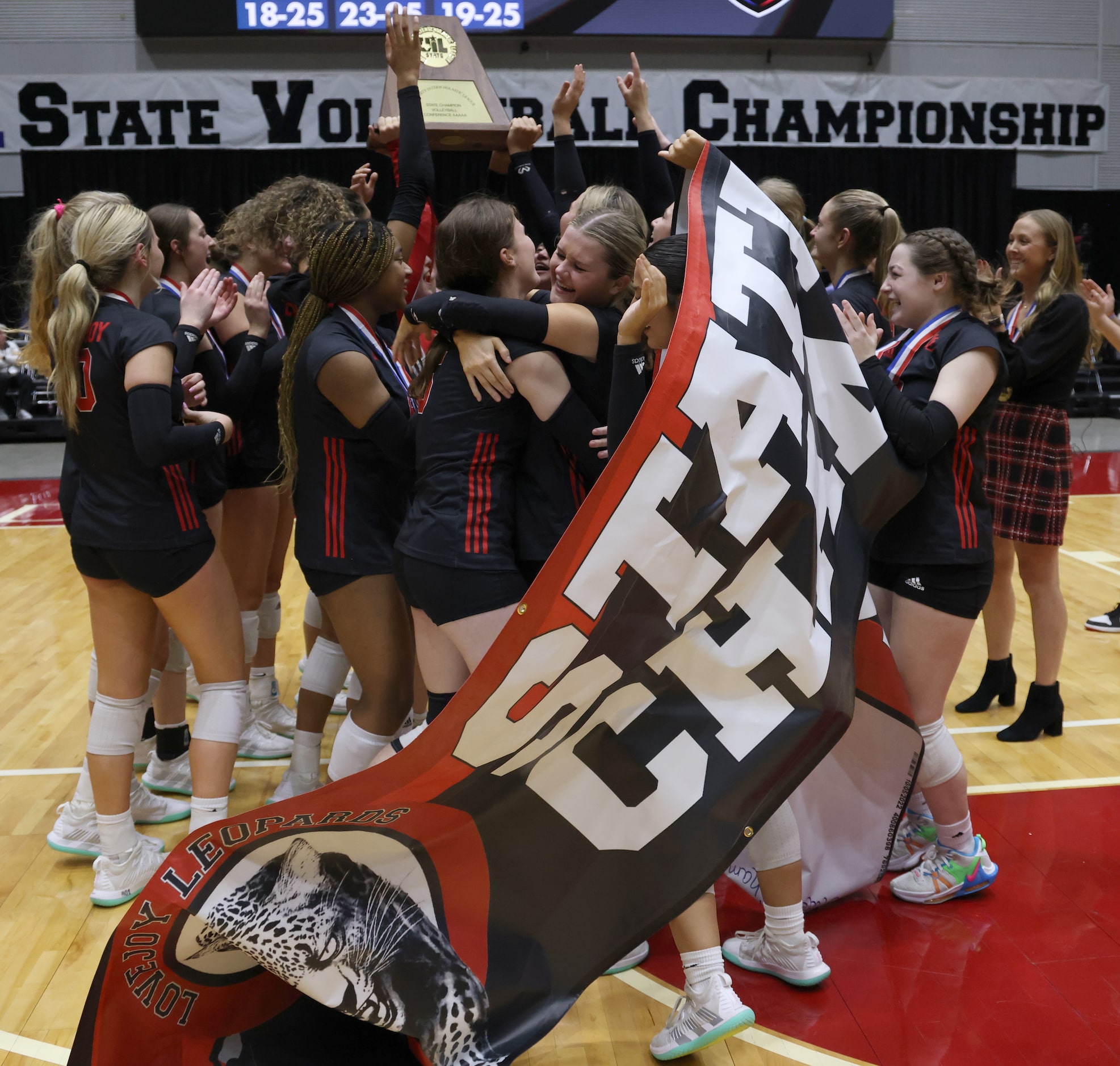 Lucas Lovejoy players and coaches celebrate their straight sets victory over Liberty Hill to...