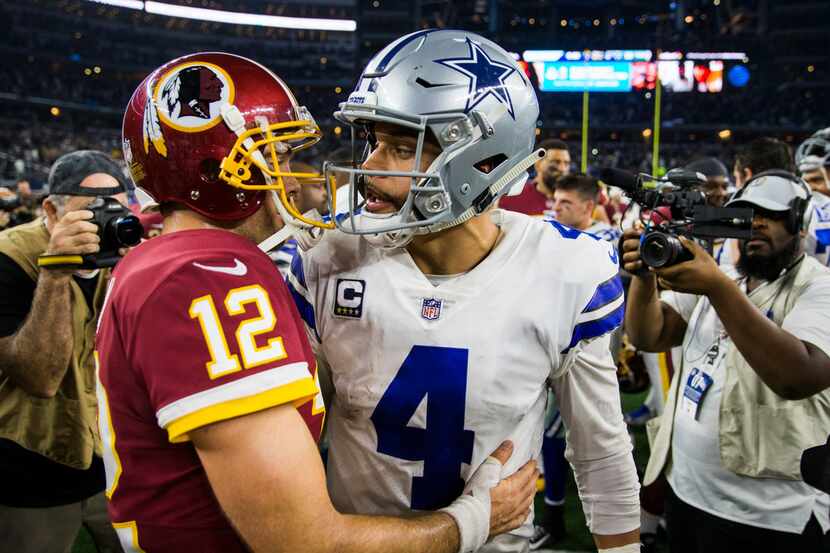 Dallas Cowboys quarterback Dak Prescott (4) hugs Washington Redskins quarterback Colt McCoy...