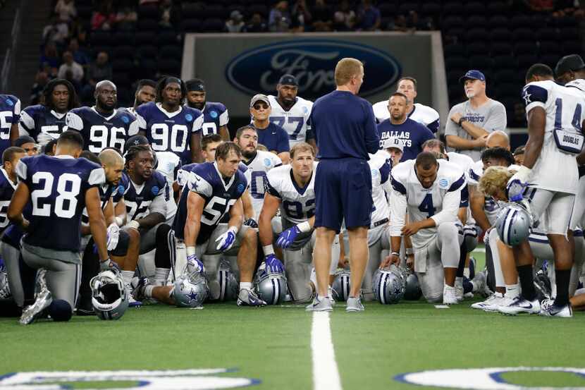 Dallas Cowboys head coach Jason Garrett talks to the team after practice during training...