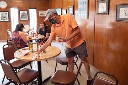 Customer Pat Bywaters lends a hand by cleaning tables after eating lunch at Mac's Bar-B-Que...