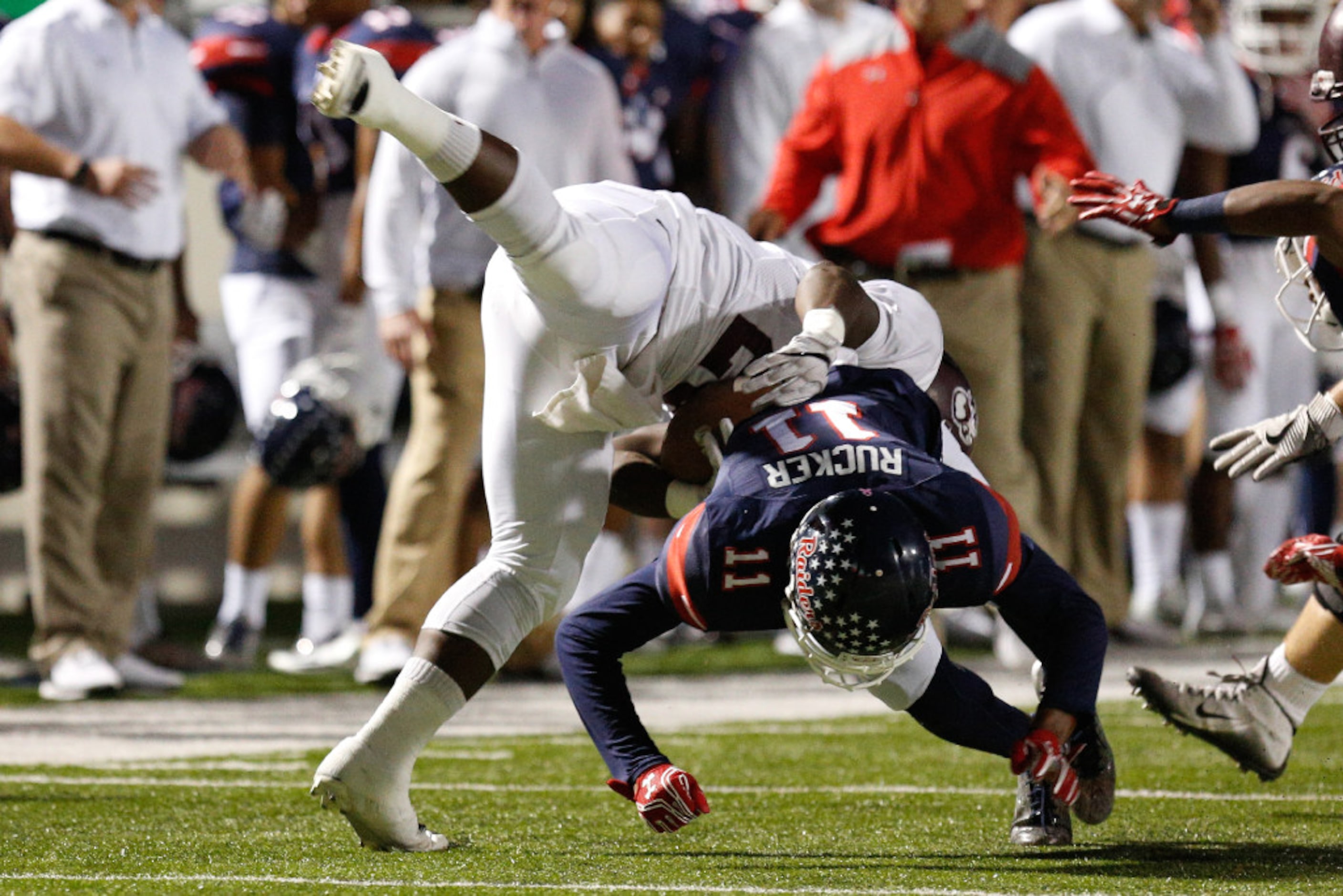 Ryan junior cornerback Jordan Rucker (11) lowers his shoulder to tackle Sherman running back...