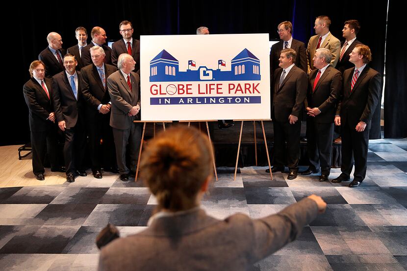 Team photographer Kelly Gavin arranges executives with the Texas Rangers, Globe Life...