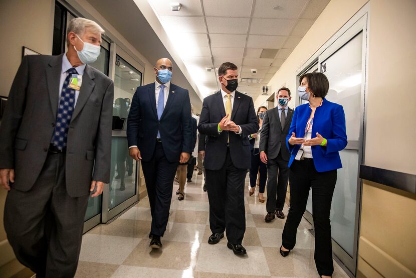 U.S. Labor Secretary Martin Walsh (center) toured the Garland Veterans Affairs Medical...