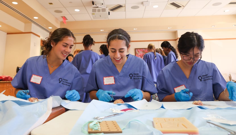 North Texas high schooler Fernanda Santos (left) looks over at Sibelle Zambie’s work as they...