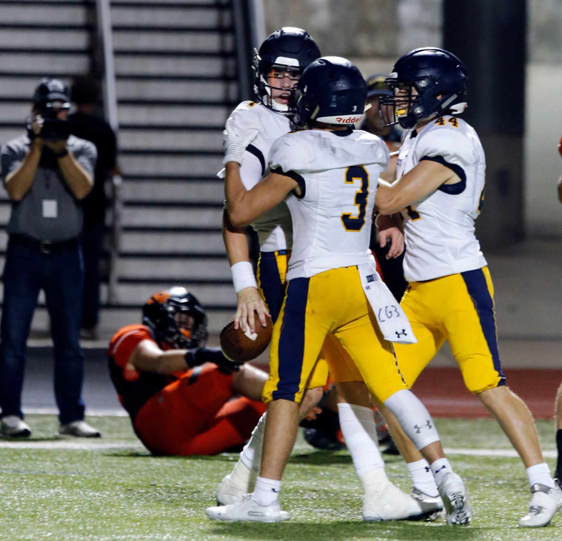 Highland Park quarterback Chandler Morris (4) in congratulated by teammates after scoring a...