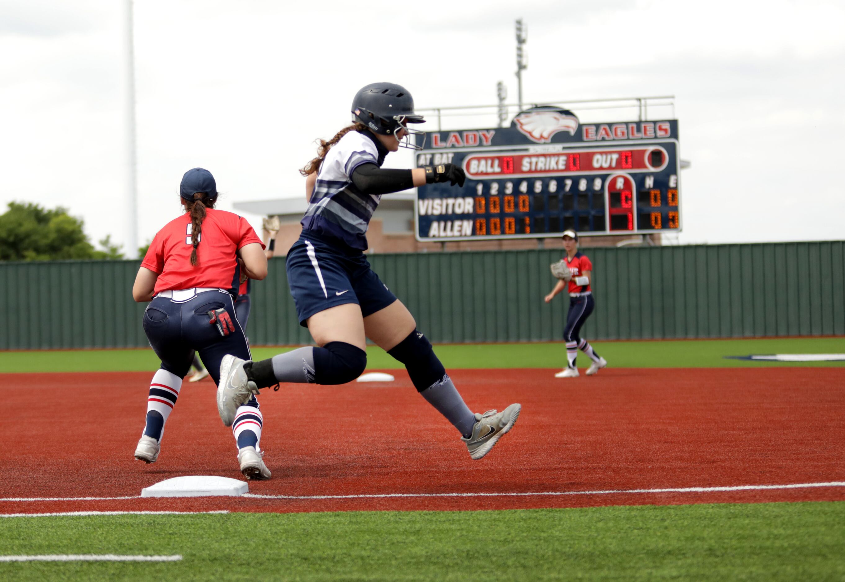 Flower Mound High School player #20, Katie Cantrell, runs past first base during a softball...