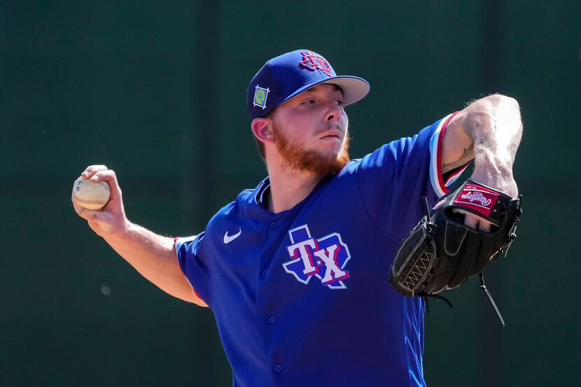 Texas Rangers pitcher A.J. Alexy throws live batting practice during a spring training...