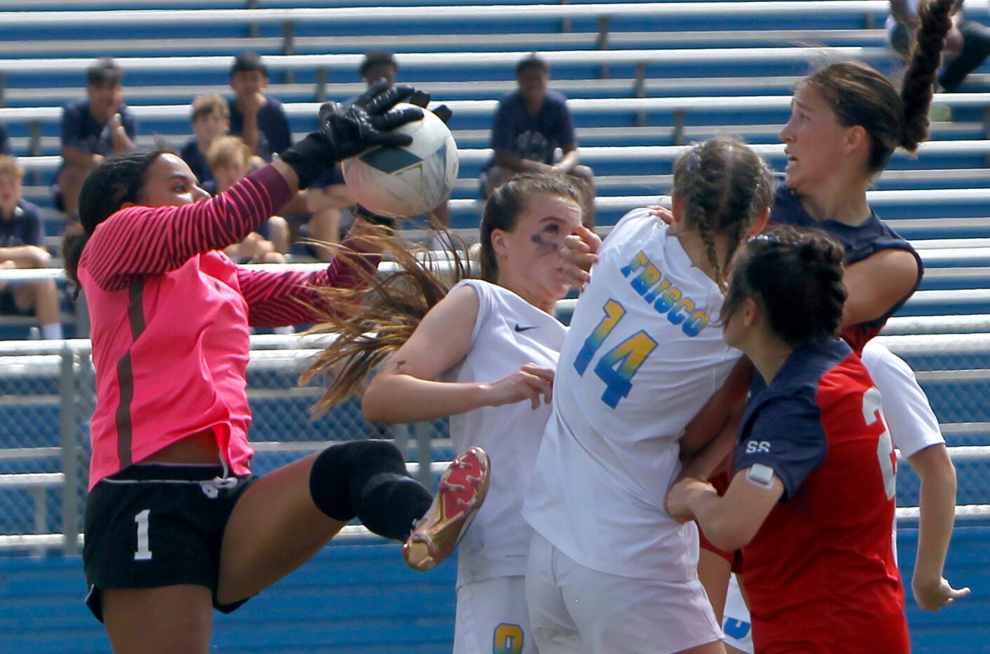 Frisco goalkeeper Ariana Anderson (1), left, leaps to gather the ball from a corner kick...