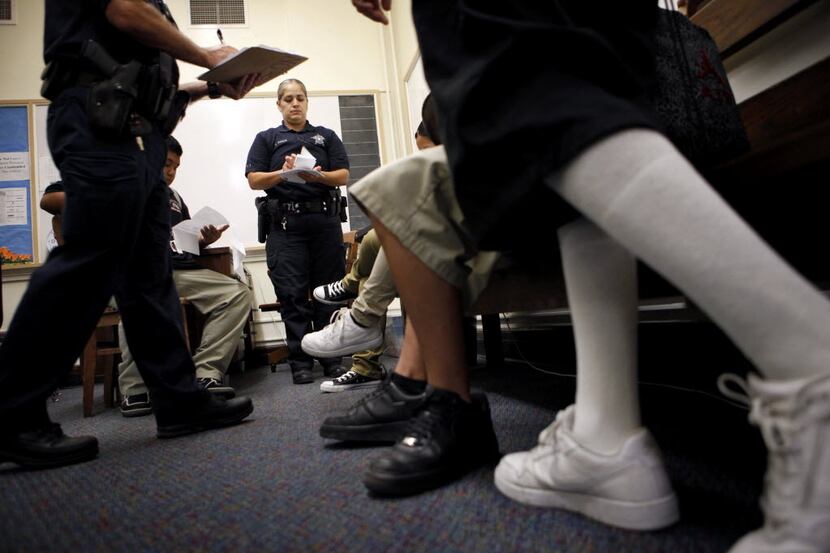 A truancy officer serves students with notices for their truancy hearings in 2011.