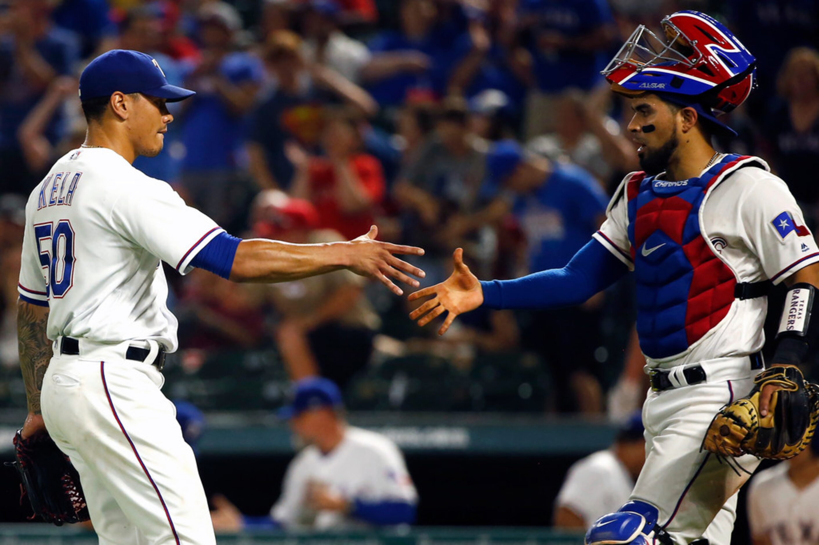 Texas Rangers relief pitcher Keone Kela (50) and catcher Robinson Chirinos shake hands...