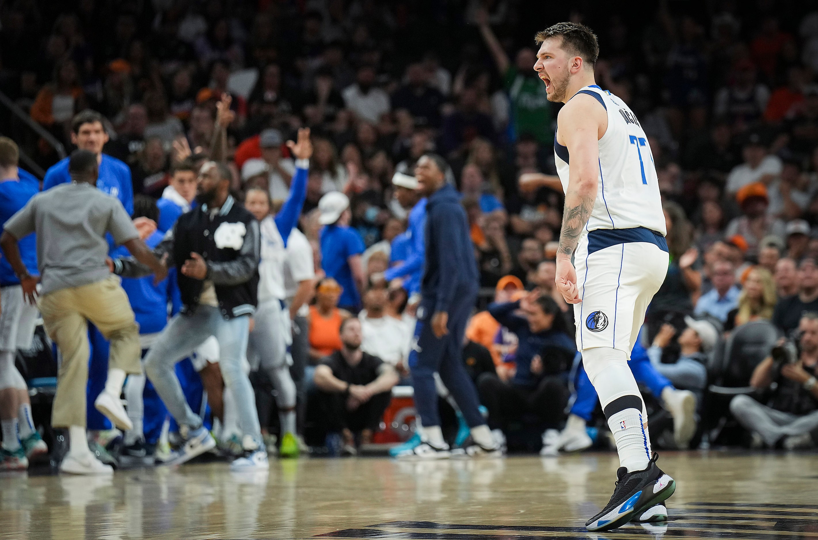 Dallas Mavericks guard Luka Doncic celebrates after hitting a 3-pointer during the second...