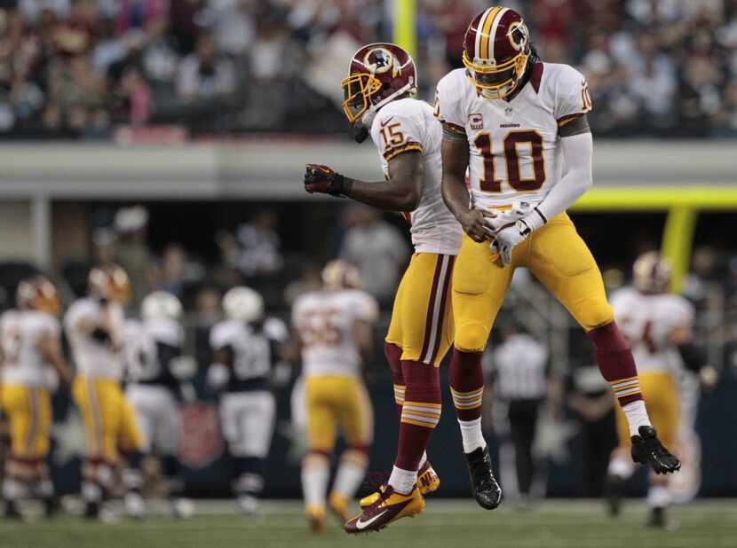 Washington Redskins wide receiver Josh Morgan (15) and quarterback Robert Griffin III (10)...