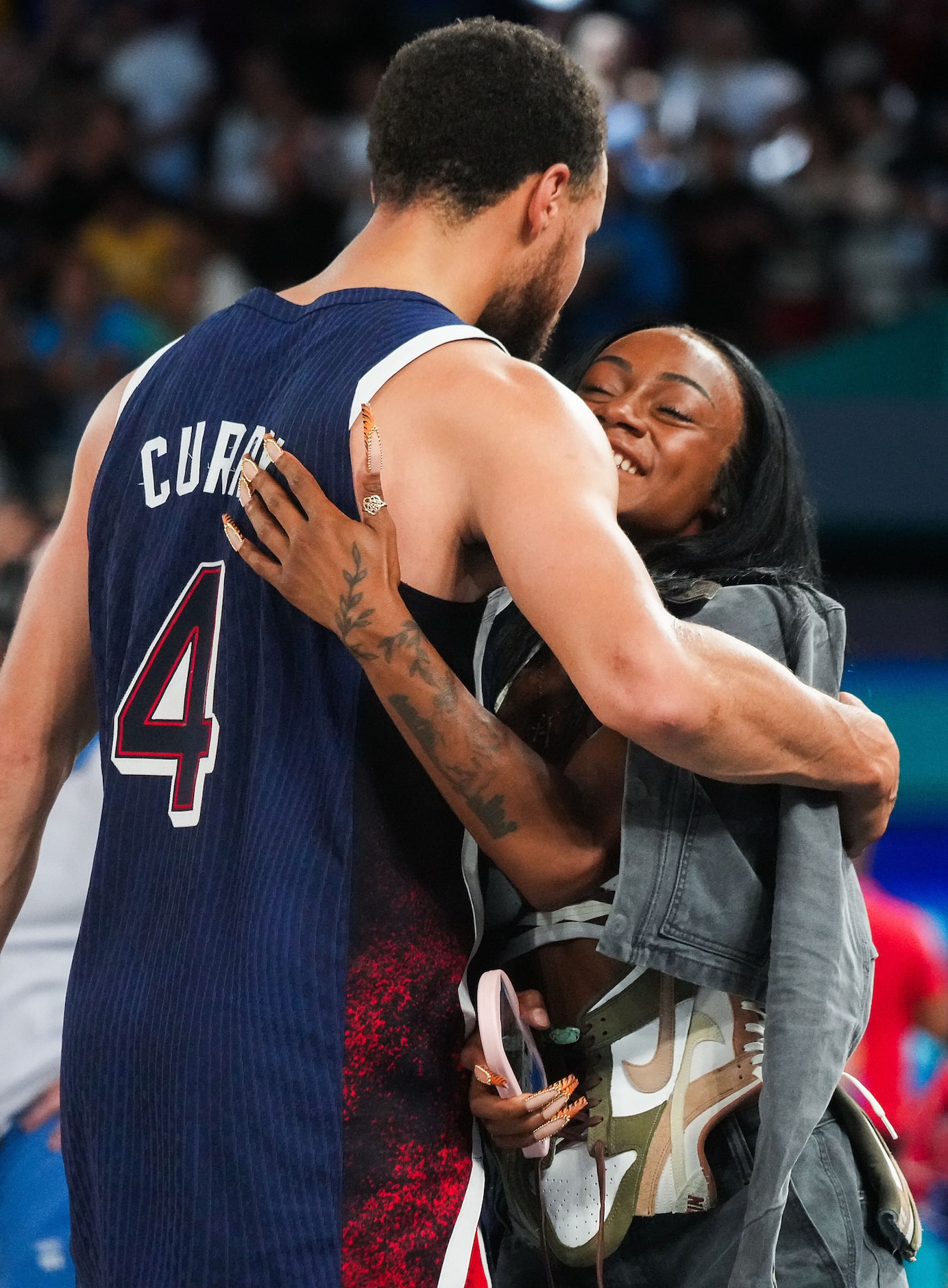 Stephen Curry of the United States hugs Sha’carri Richardson as they celebrate after a...