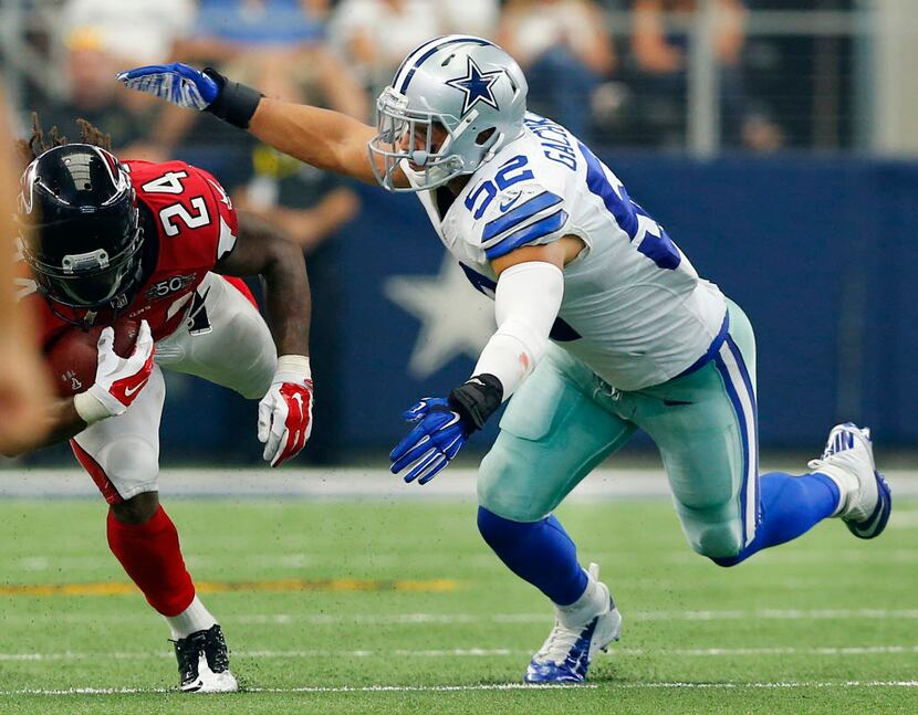 Dallas Cowboys linebacker Andrew Gachkar (52) makes a tackle of Atlanta Falcons running back...