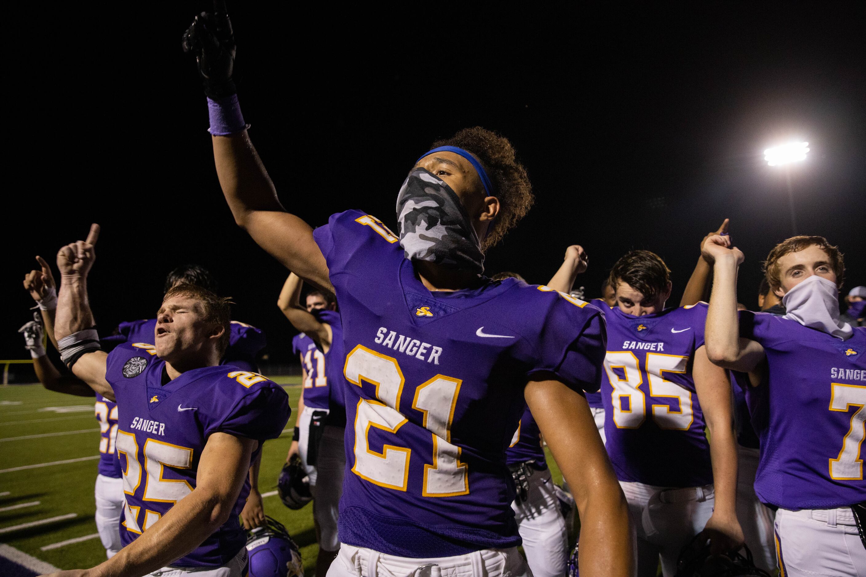 Sanger High School player CJ Flowers (21) celebrates with his team after winning against...