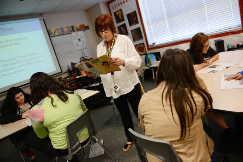 
Karen Martin, a seventh-grade language arts teacher, reads an article to students during...
