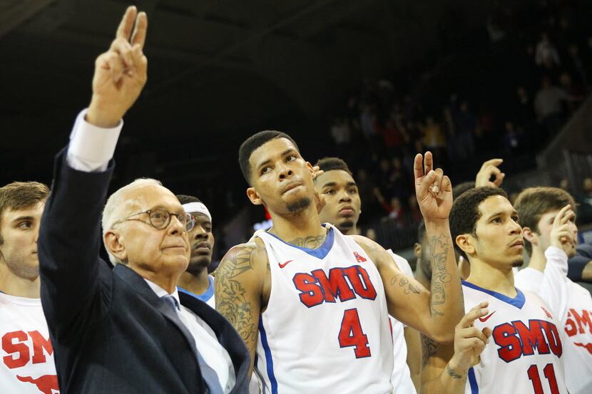 SMU guard Keith Frazier (4) looks dejected while he, Coach Larry Brown and teammates listen...
