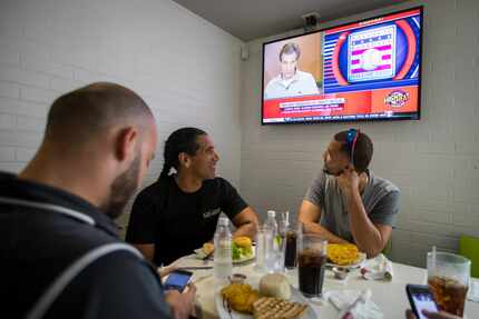 Alex Claudio (right) and his trainer Luis Cadiz look up as news of this year's National...