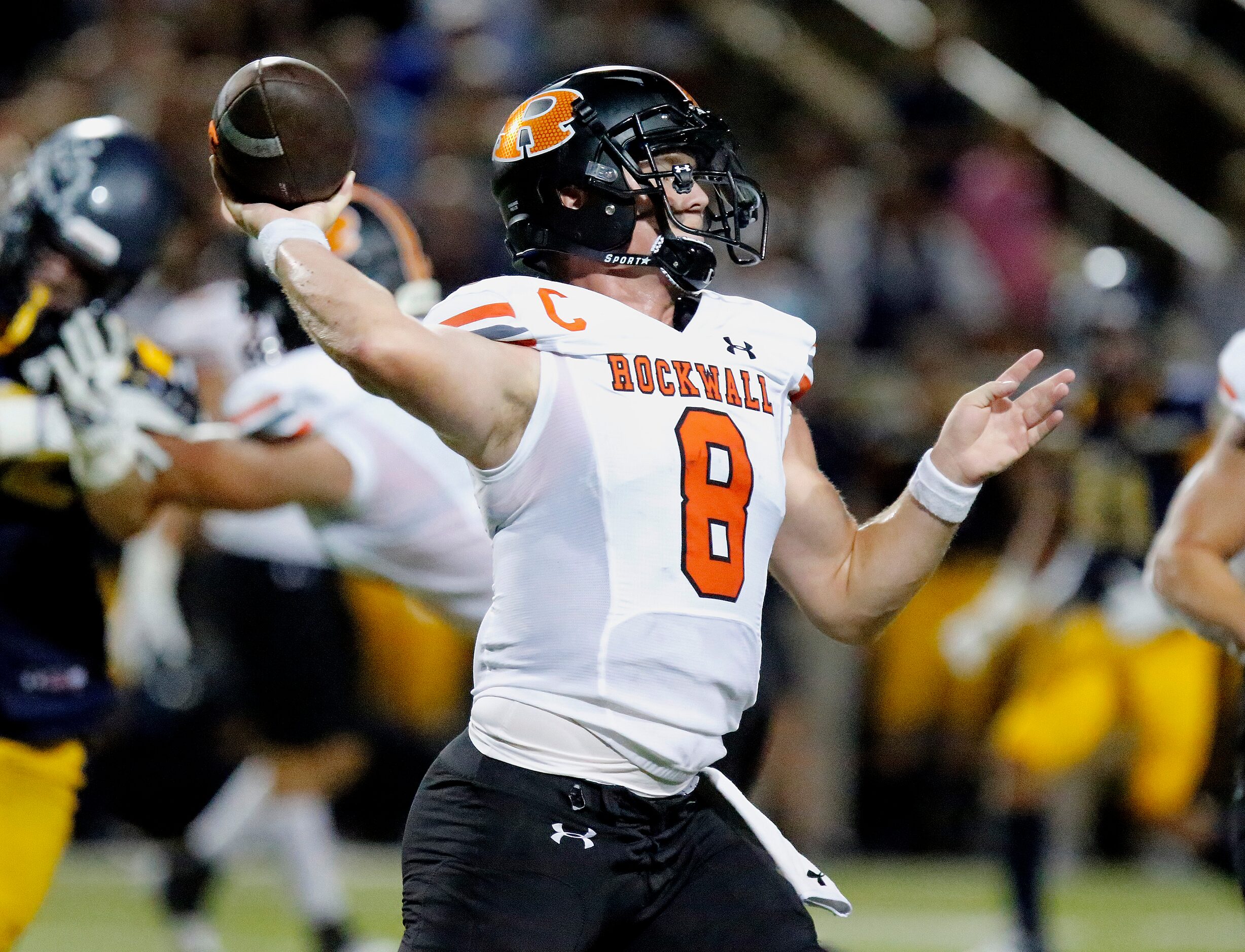 Rockwall High School quarterback Braedyn Locke (8) throws a pass during the first half as...