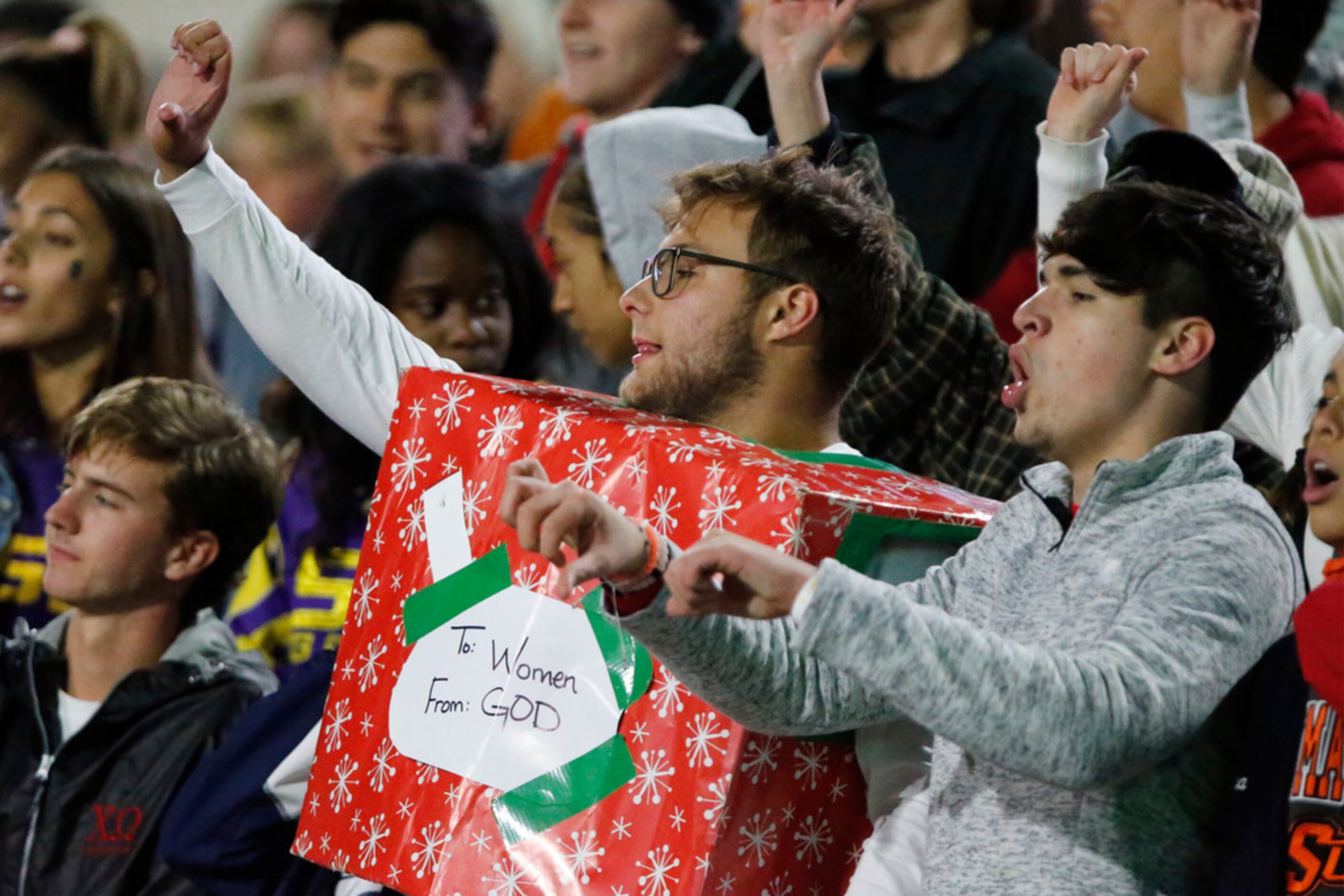 Corbin Lingo (center), 17, of Allen, questions a call as he was dressed as Godâs gift to...