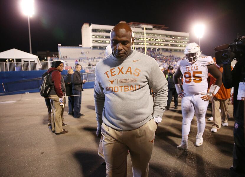 Texas coach Charlie Strong leaves the field after losing to Kansas in overtime in Lawrence,...
