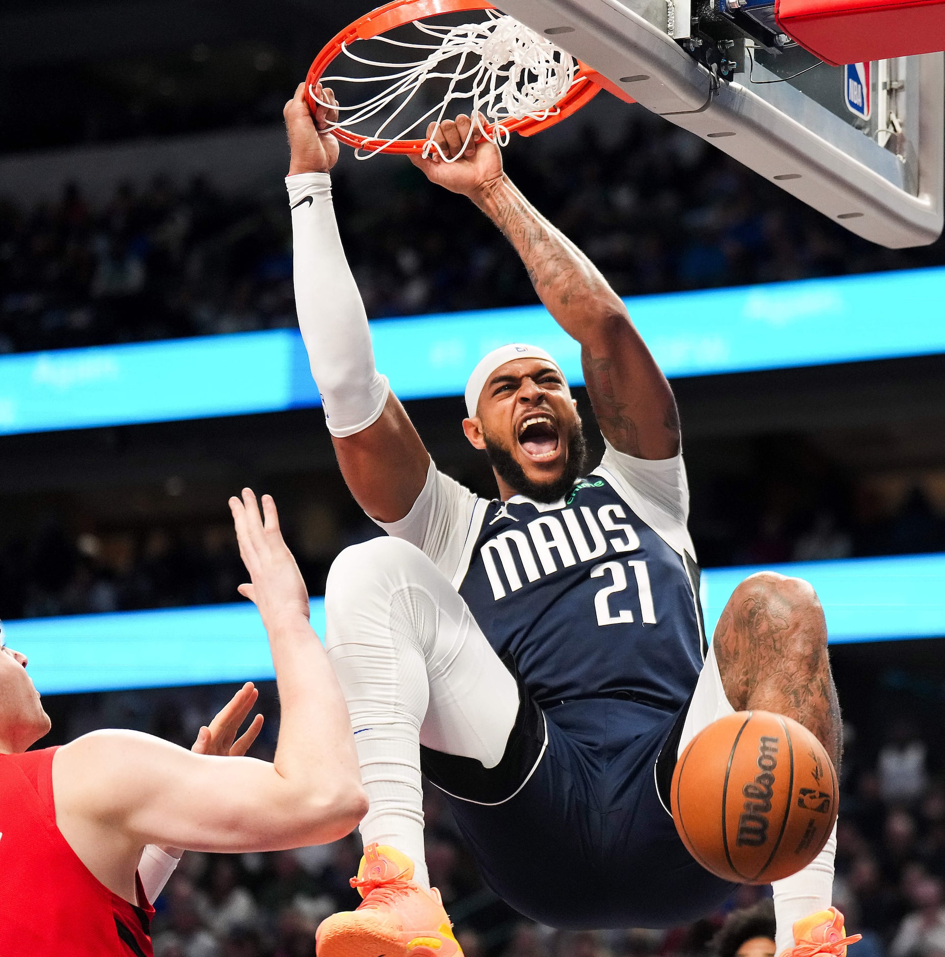 Dallas Mavericks center Daniel Gafford (21) dunks the ball past Portland Trail Blazers...