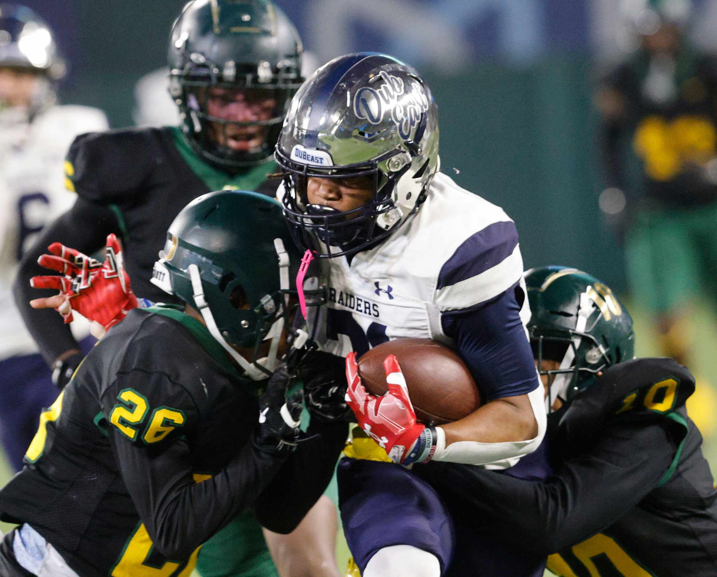 Wylie East's Michael Henderson (21) carries the ball as DeSoto's Antrone White (26) and...