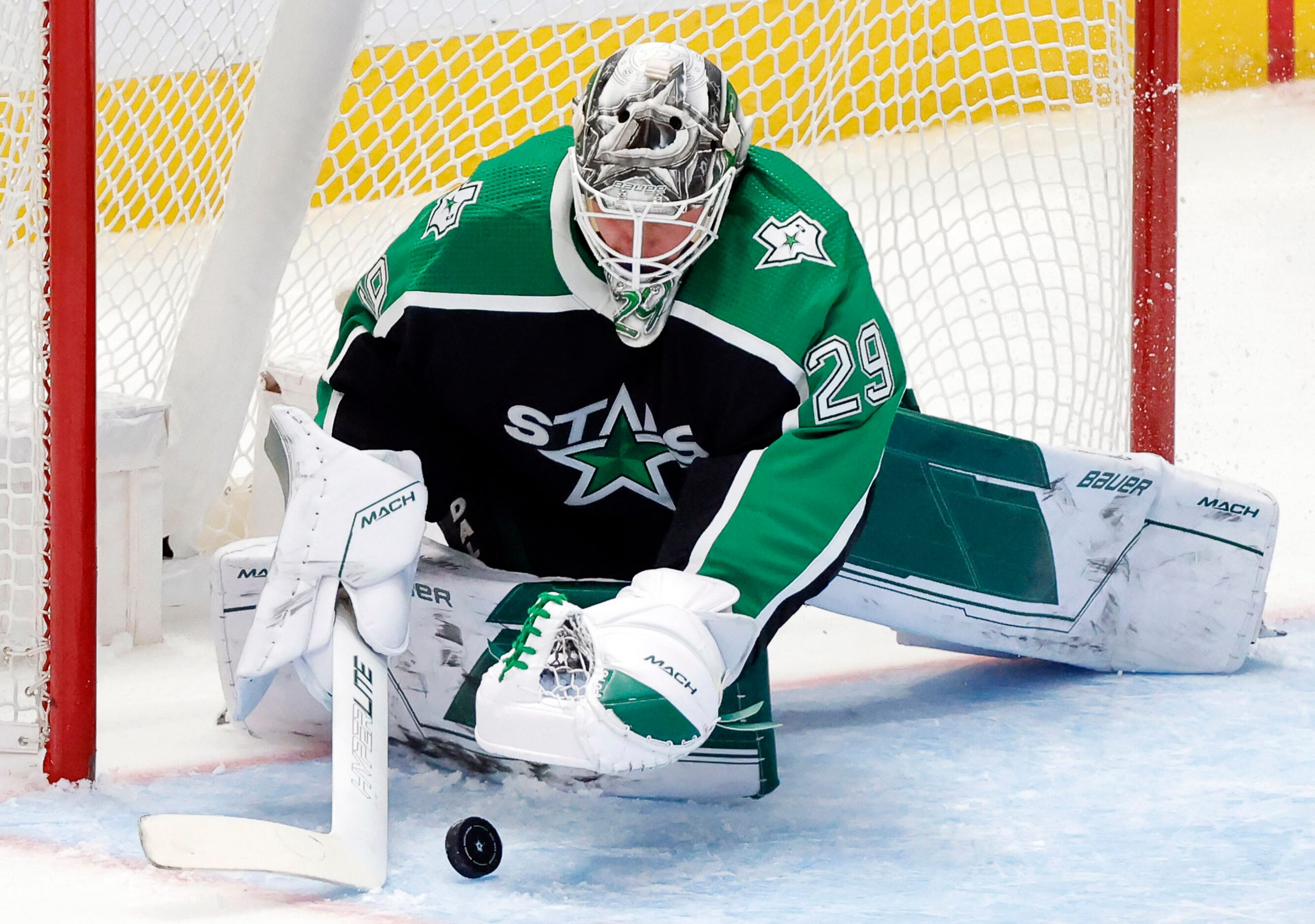 Dallas Stars goaltender Jake Oettinger (29) covers a  second period shot by the Anaheim...