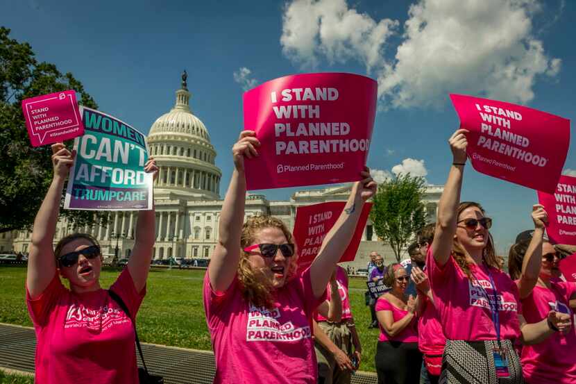  Demonstrators show their support for Planned Parenthood during a health care rally outside...