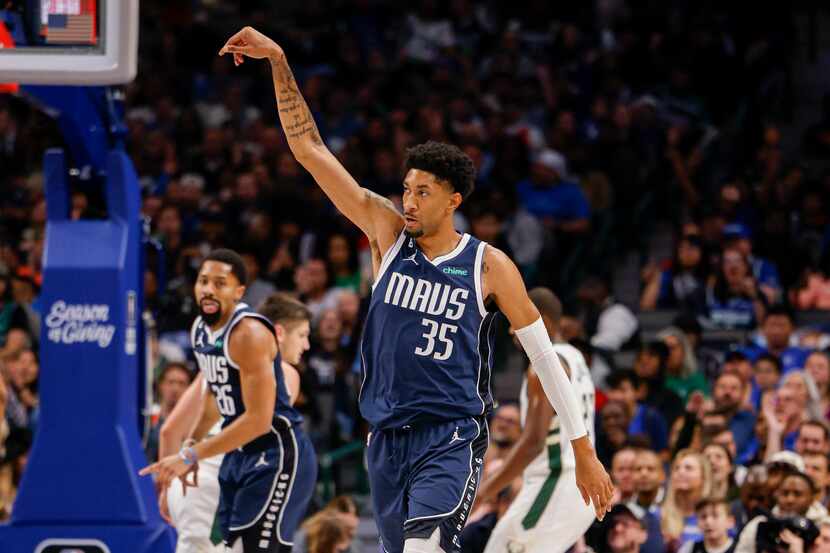 Dallas Mavericks center Christian Wood (35) celebrates after making a three-point shot...