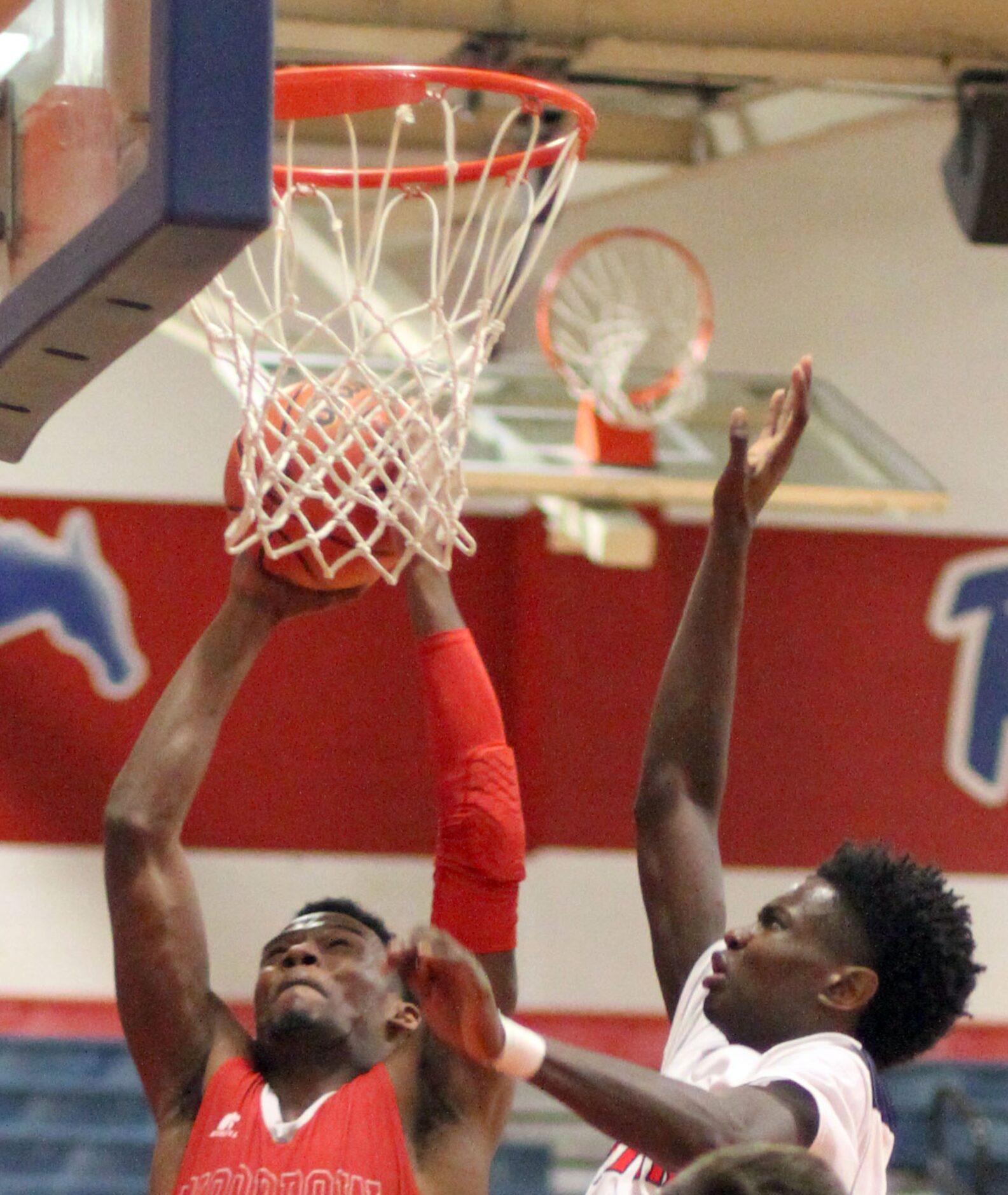 Woodrow Wilson's Hassan Thomas (3) goes strong to the basket as he is defended by Frisco...