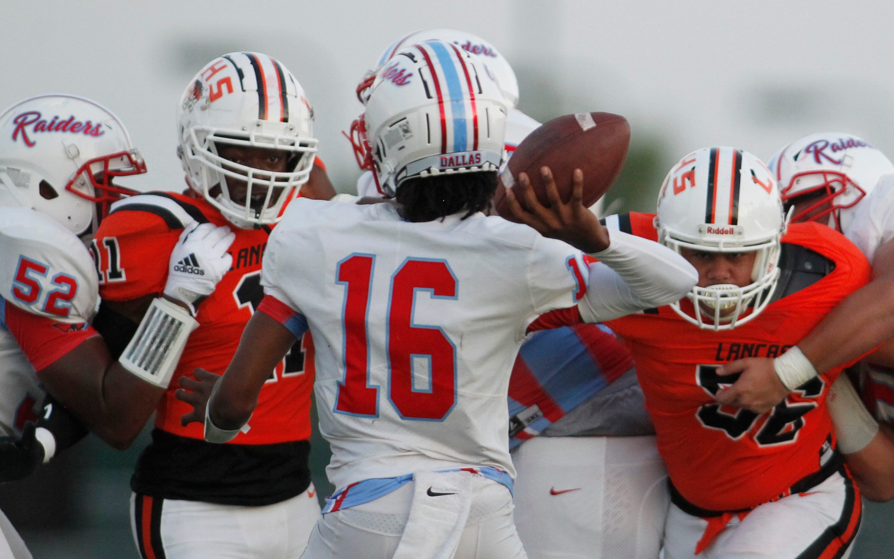 Dallas Skyline quarterback LaTraevian Freeman (16) looks to pass as he feels the pressure...