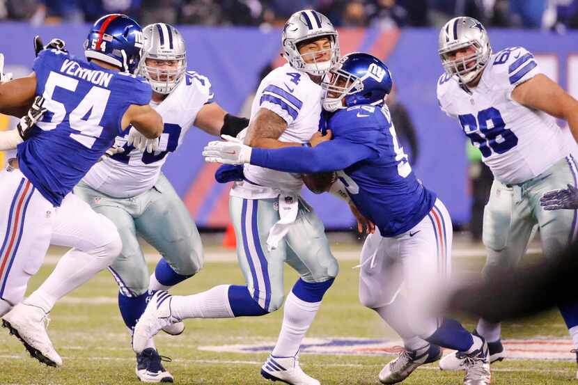 Dallas Cowboys quarterback Dak Prescott (4) fumbles as he is hit by New York Giants nose...