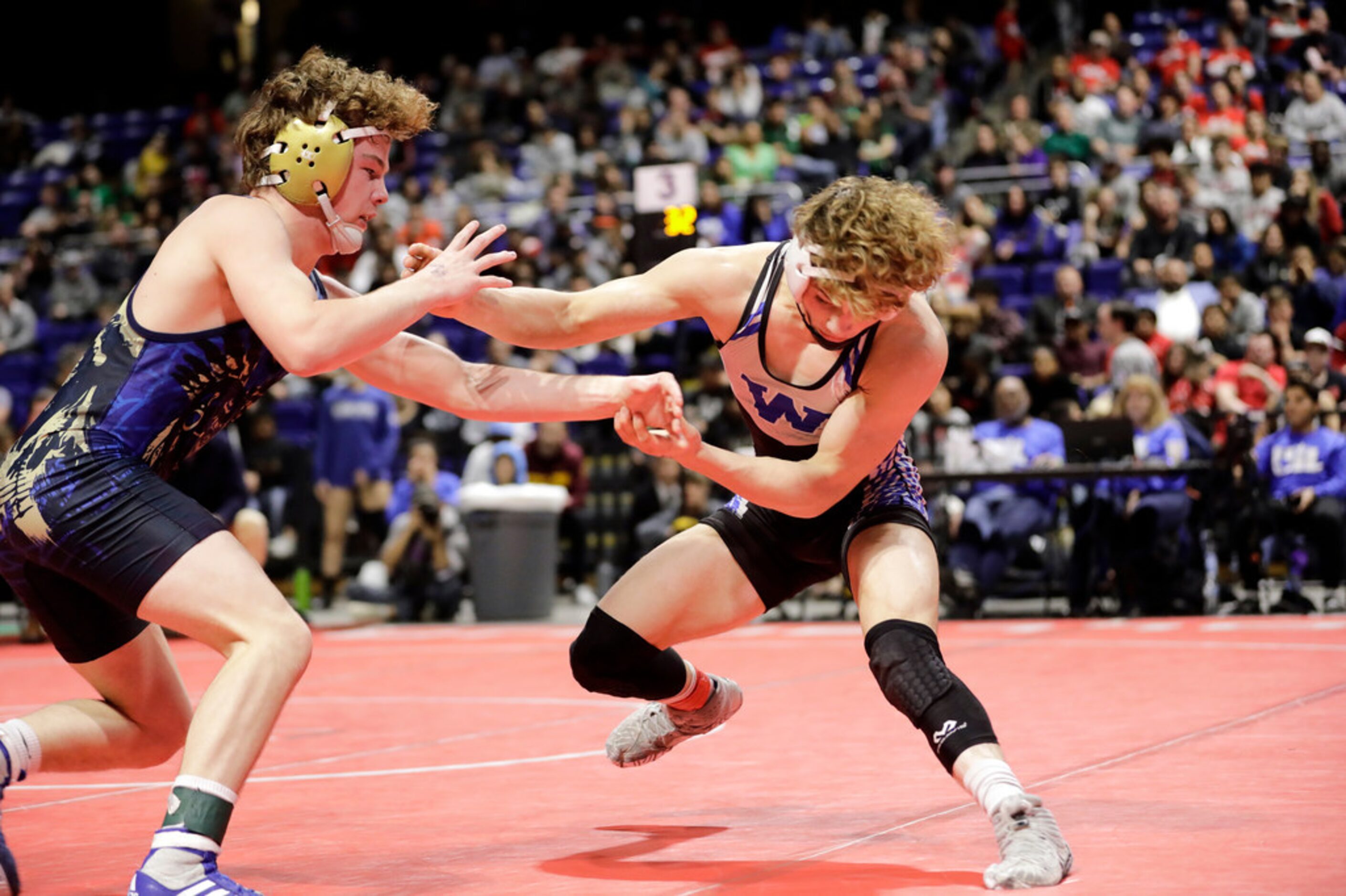 Parker Decker of Keller wrestles against Tagen Jamison of Plano West during the UIL Texas...