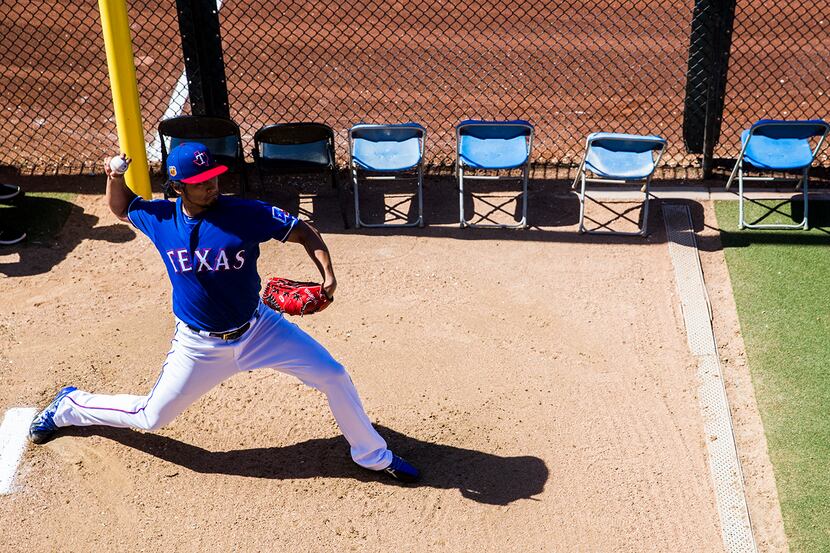 Texas Rangers starting pitcher Yu Darvish (11) warms up in the bullpen before a spring...