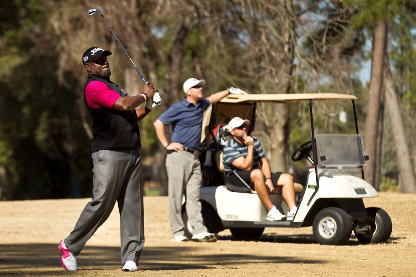 Former Dallas Cowboys and Hall of Fame running back Emmitt Smith hits a fairway shot, with...