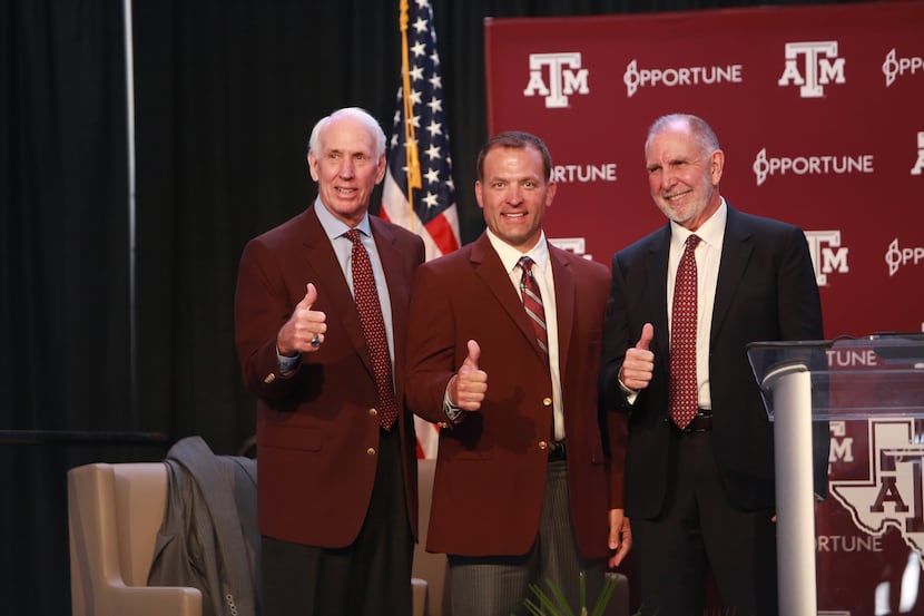 Texas A&M's interim Athletic Director R.C. Slocum poses alongside new Athletic Director Ross...