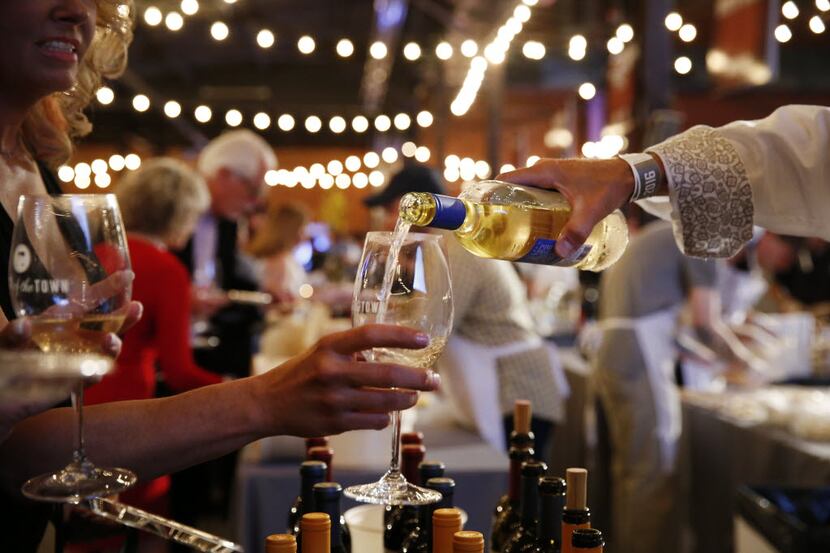 Wine is poured during the Grand Tasting event at Savor Dallas at Fair Park in Dallas...