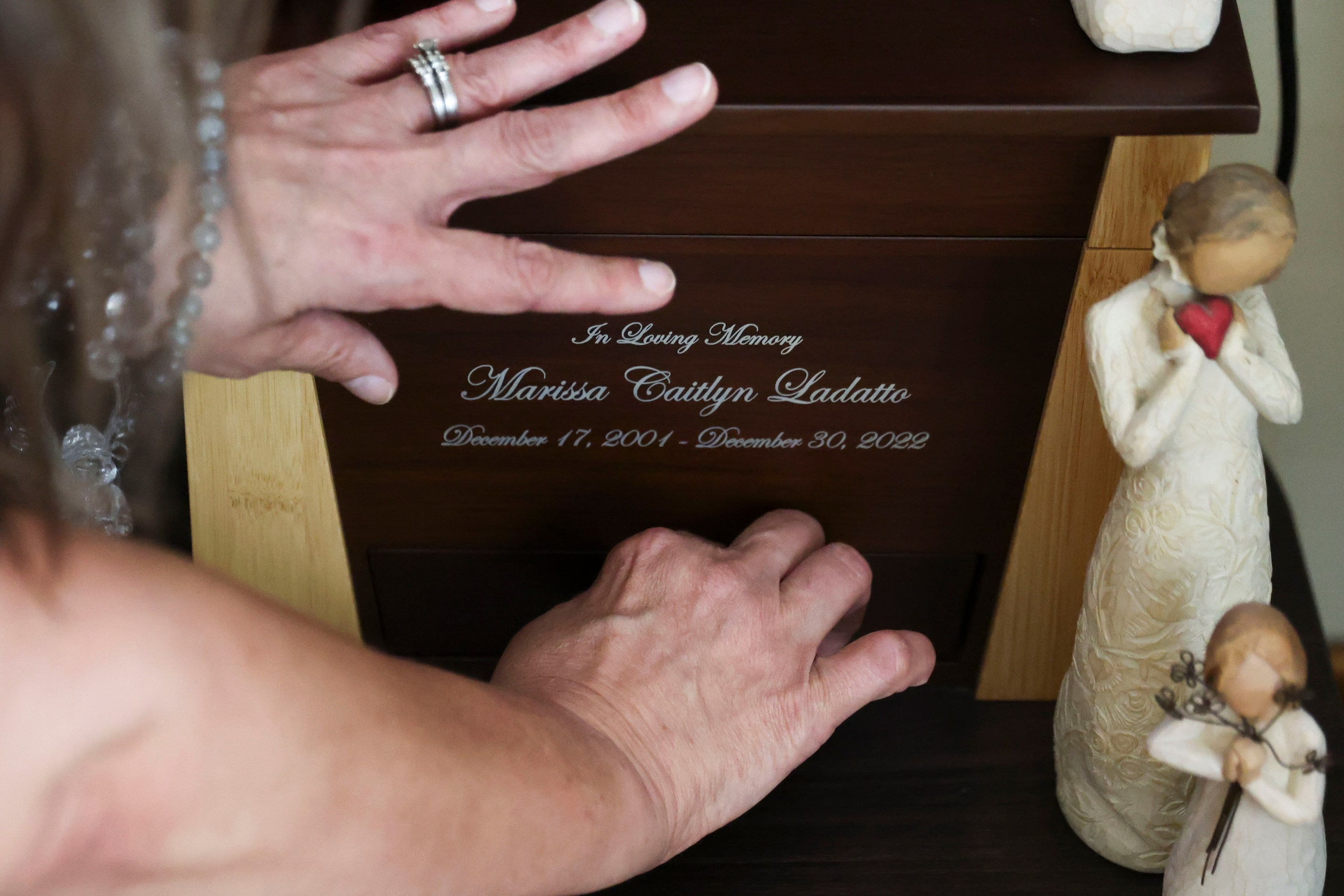 Brewer touches her daughter's urn on Tuesday at the family's Duncanville home. Brewer said...