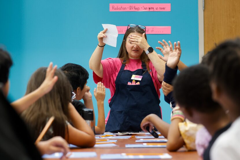 Penny Sessions, an educator with the Fort Worth Science and History Museum, closes her eyes...