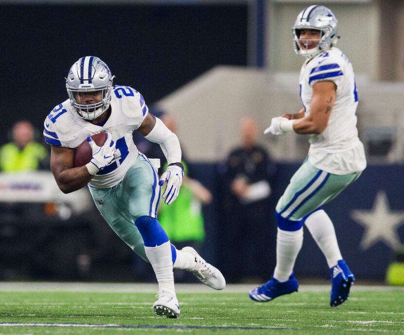 Dallas Cowboys running back Ezekiel Elliott (21) runs the ball after a handoff from...